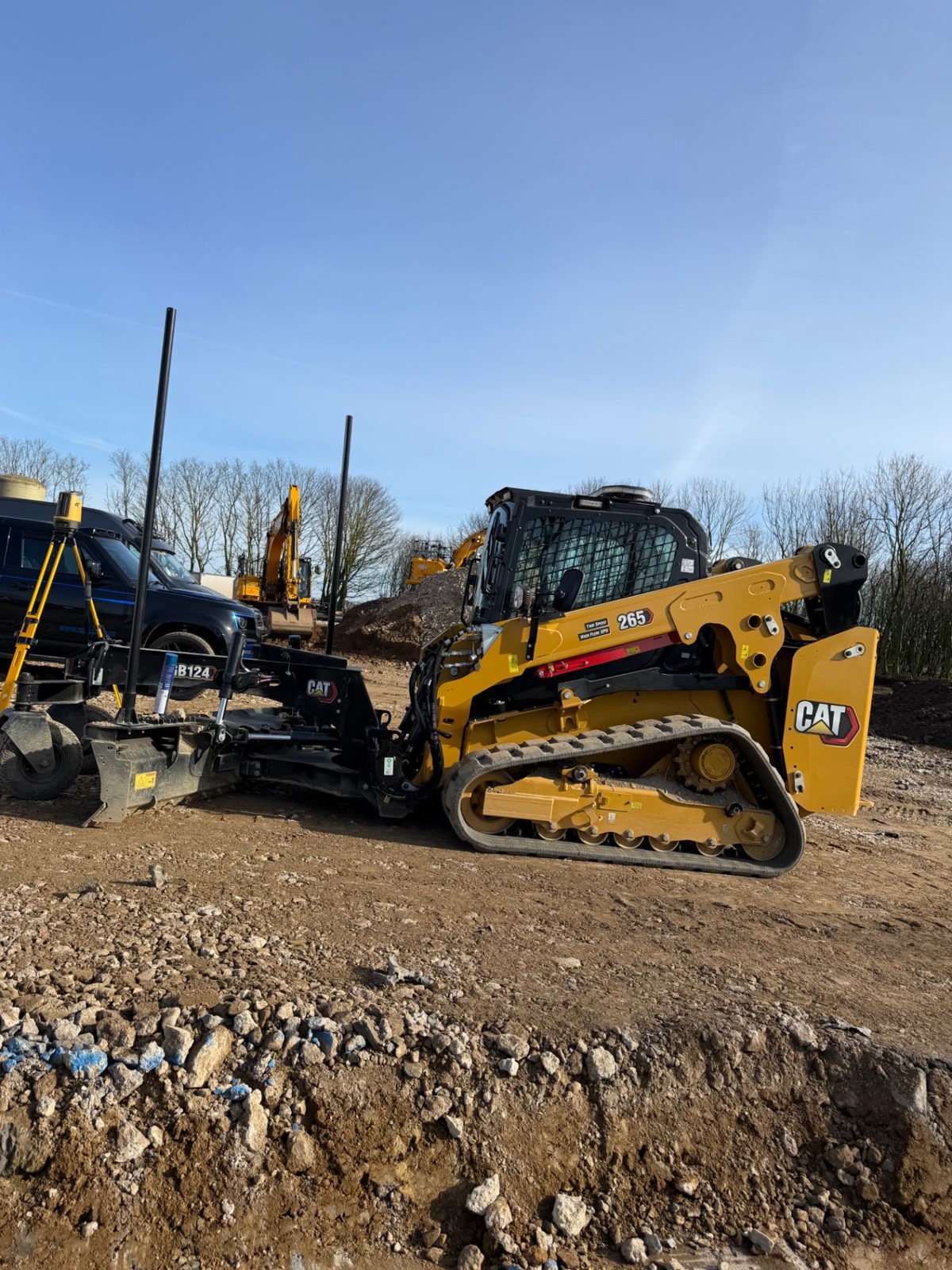 RPD CAT 265 compact track loader with grading attachment on an earthworks site