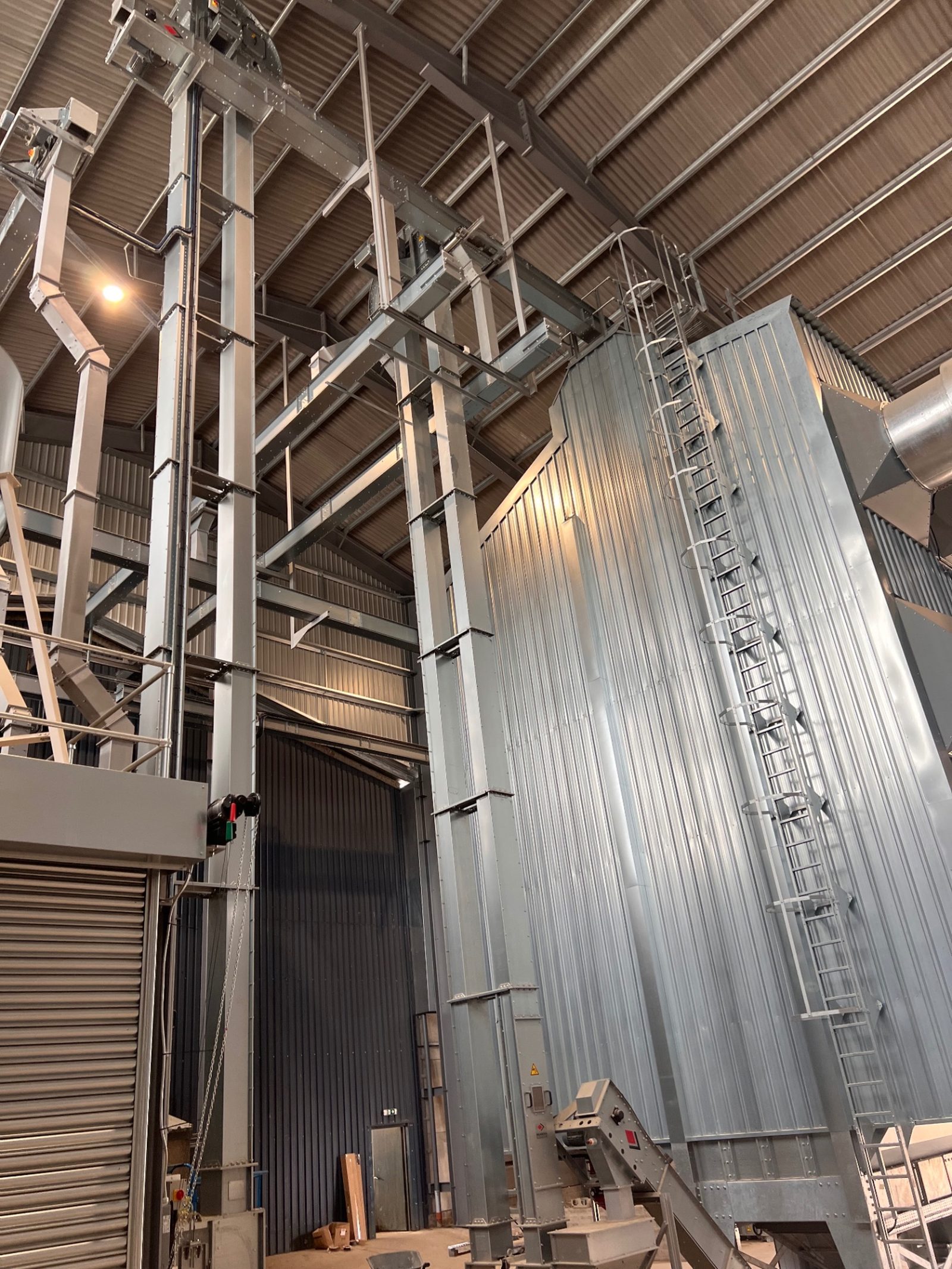 Grain handling plant and silver ducting inside the completed grain storage building