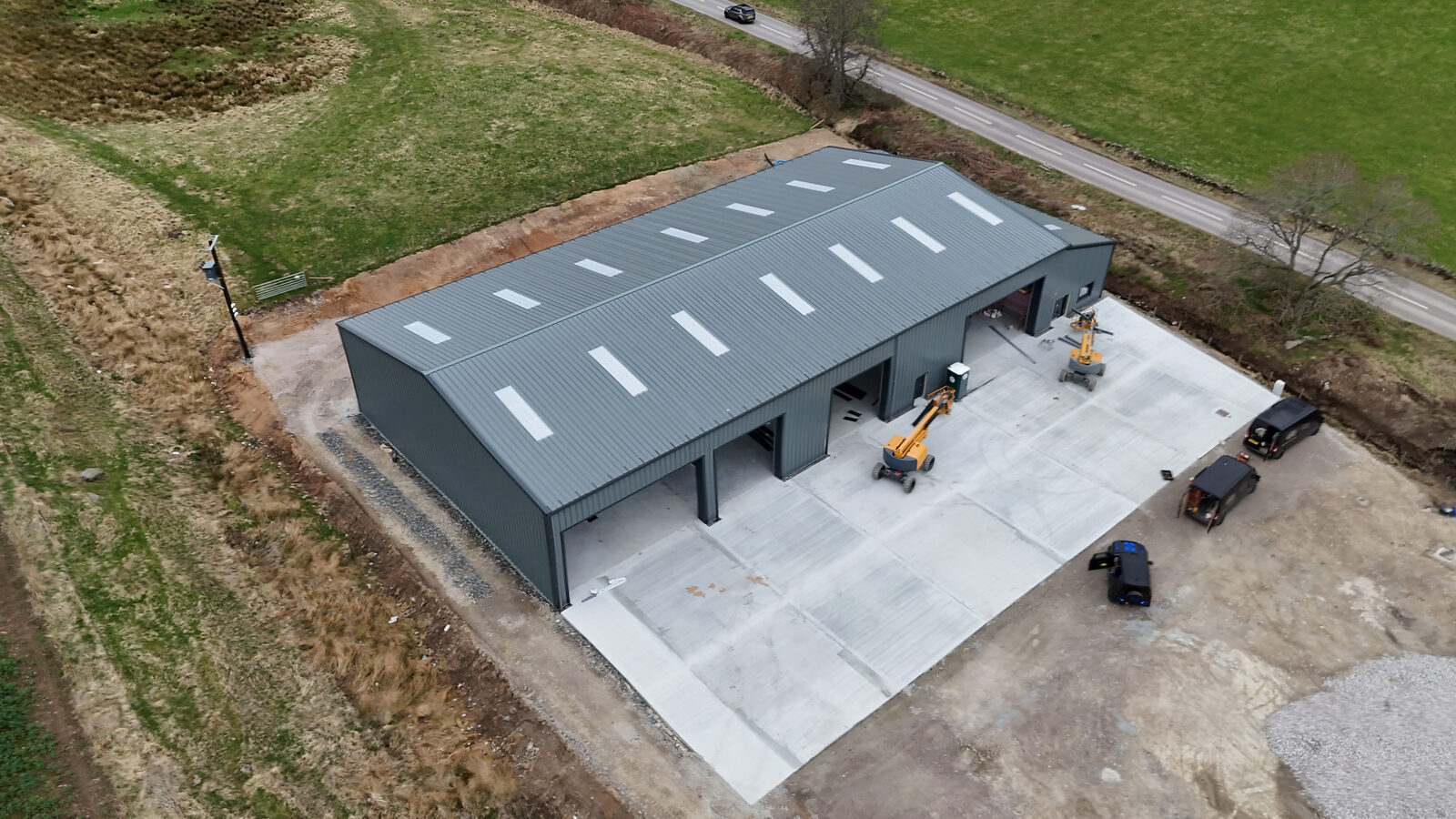 Raised aerial view across the completed industrial building and lean-to