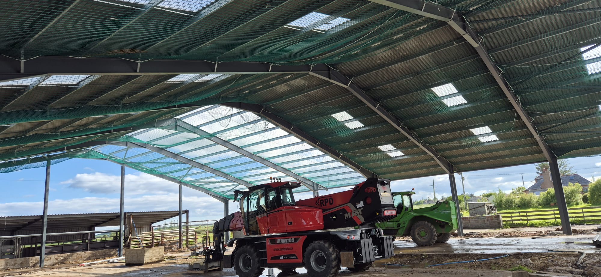 RPD-liveried Manitou MRT 2660 rotating telehandler working inside a steel-framed agricultural building