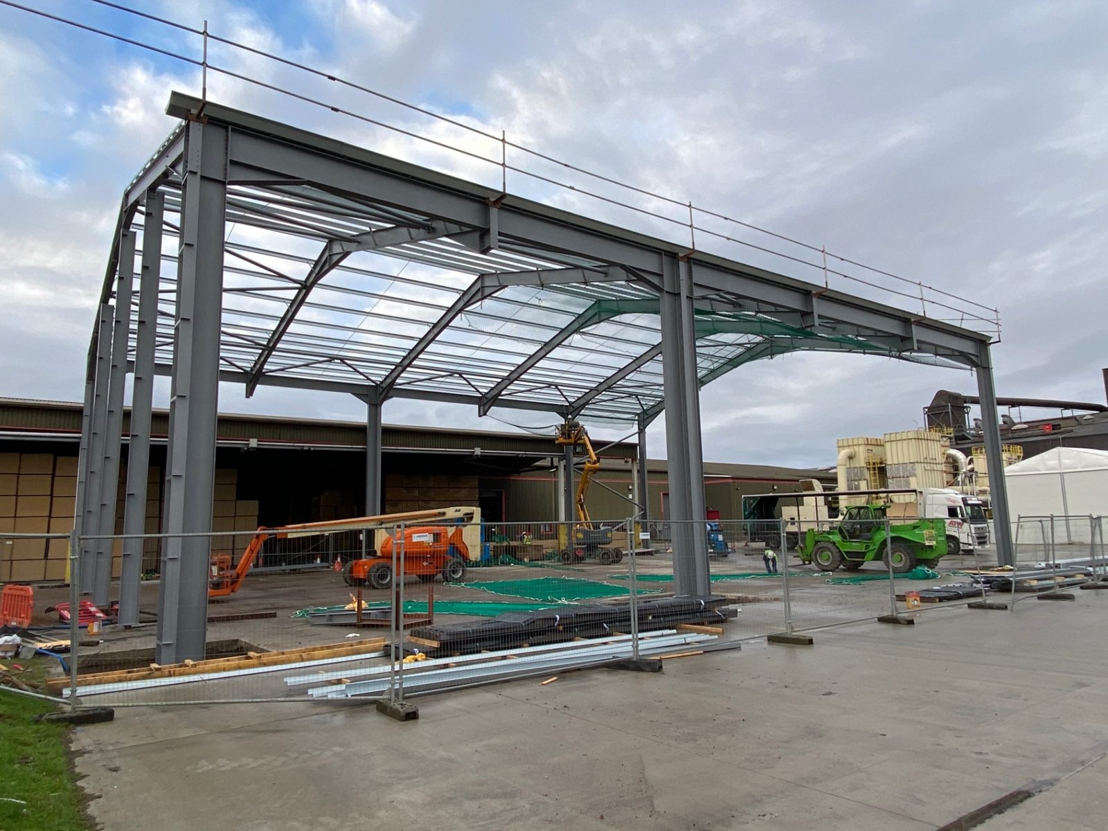Erected steel canopy frame under a clear sky at the Highlands site