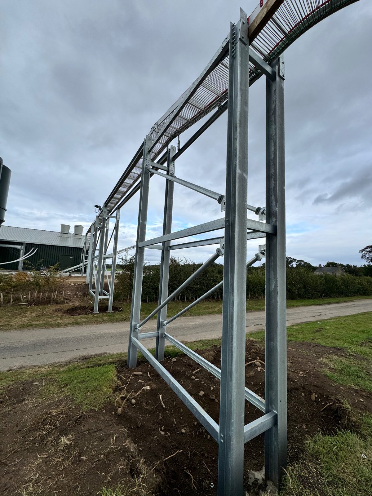 Ground-level view of the completed egg conveyor bridge over the articulated vehicle route