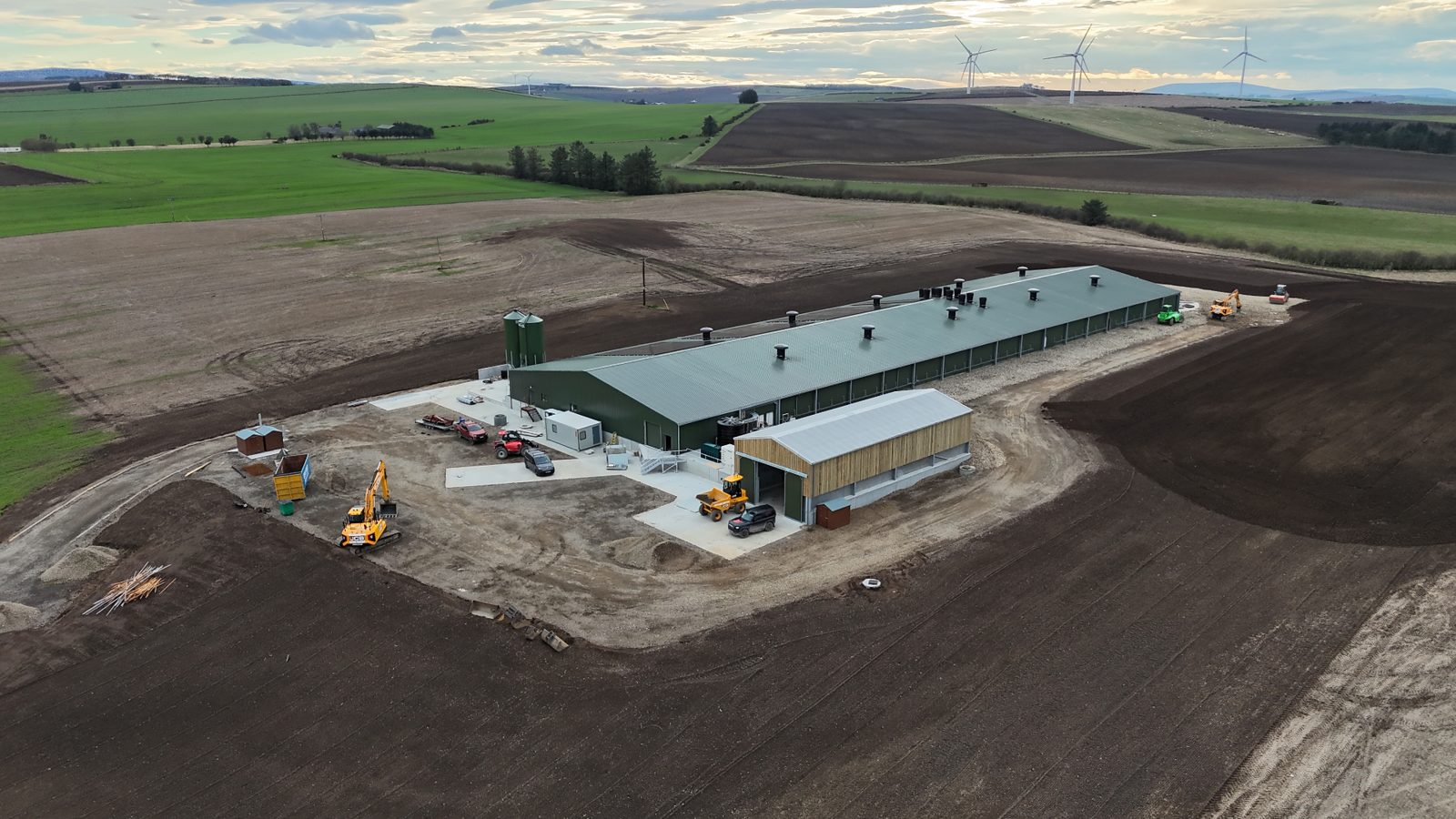 Overhead aerial view of the free-range poultry site with buildings, concrete aprons and fields